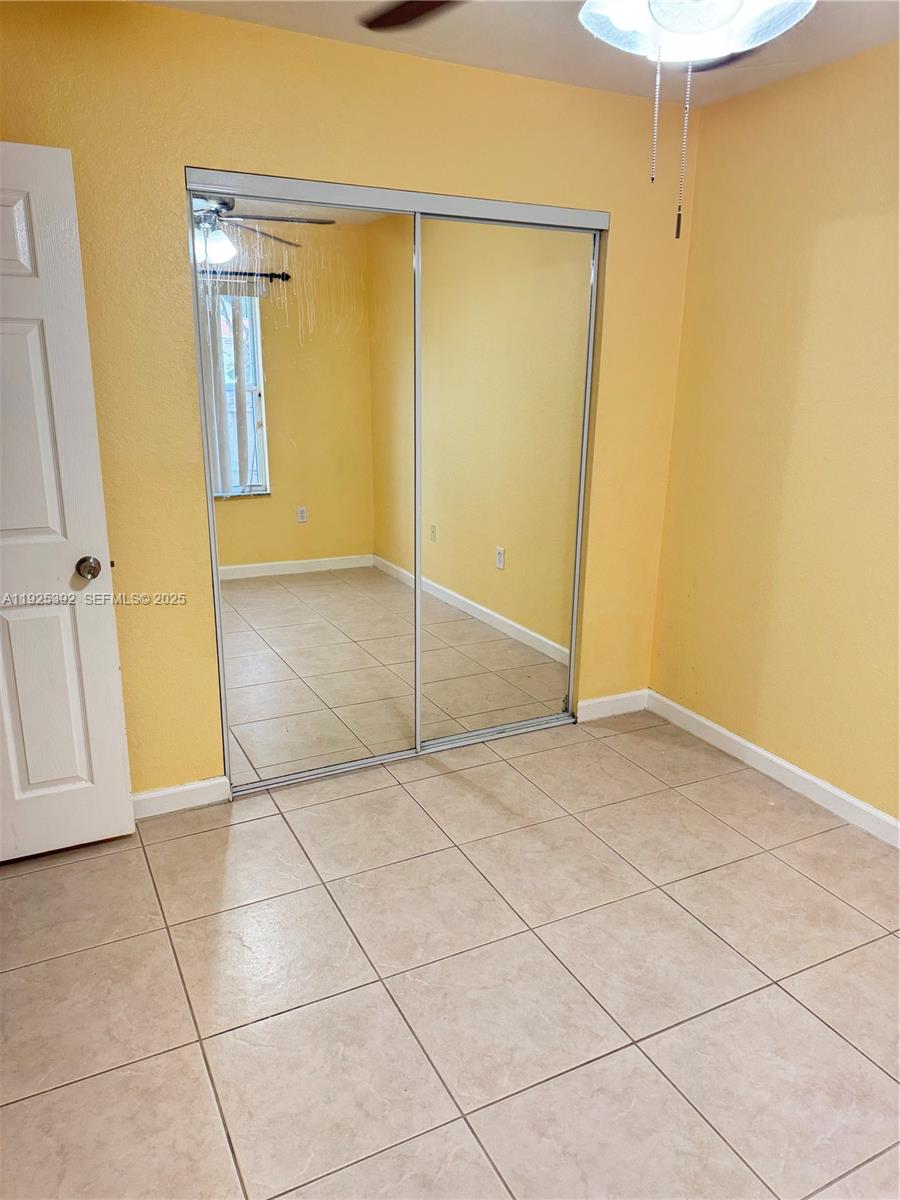 23953 Southwest 108th Court Homestead, FL 33032 - Photo 10 of 25 a view of an empty room with wooden floor