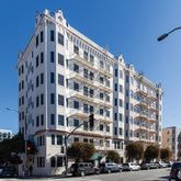 a view of a tall building and a street light pole