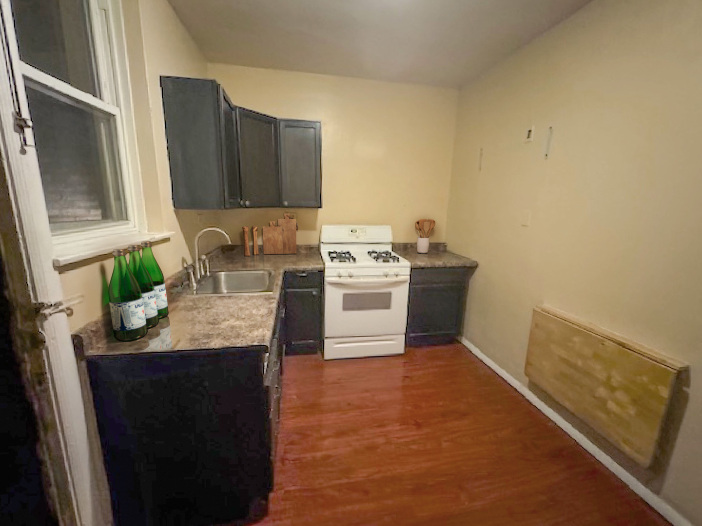 2425 West Pratt Boulevard, Unit 3I Chicago, IL 60645 - Photo 15 of 16 a kitchen with a sink a stove and cabinets