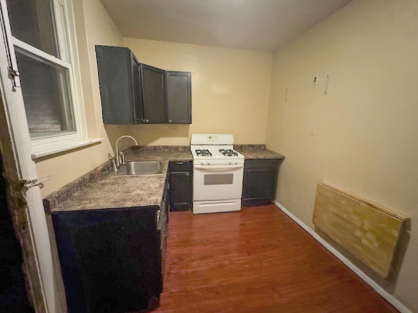 2425 West Pratt Boulevard, Unit 3I Chicago, IL 60645 - Photo 16 of 16 a kitchen with a sink stove and cabinets