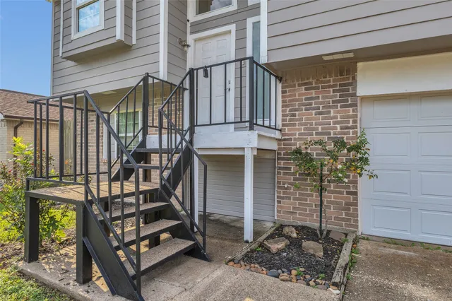 wooden floor fireplace and windows in an empty room