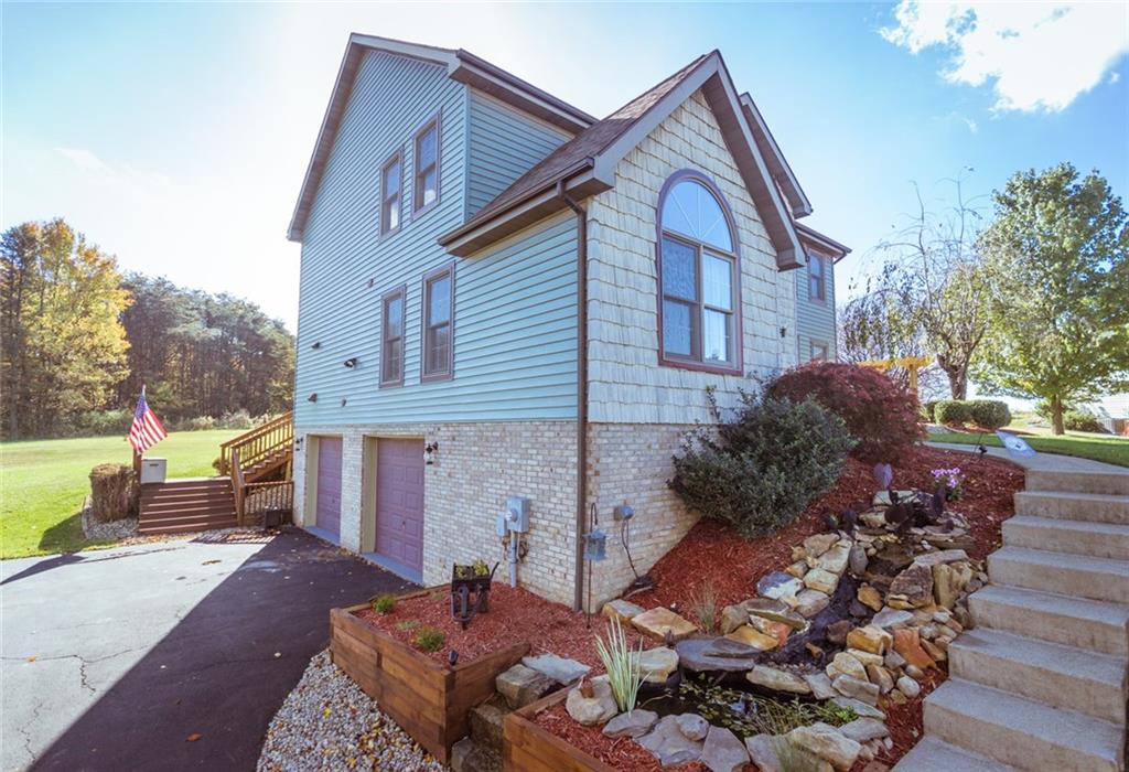 76 Firethorn Road Economy, PA 15005 - Photo 2 of 25 Beautiful landscaping with a water feature.