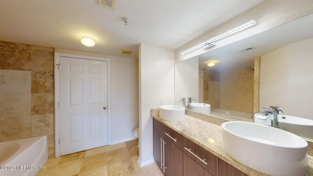 a bathroom with a double vanity sink and a mirror