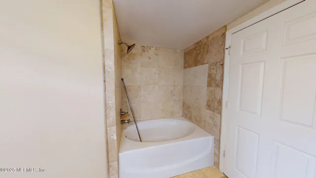 a bathroom with a tub and a shower