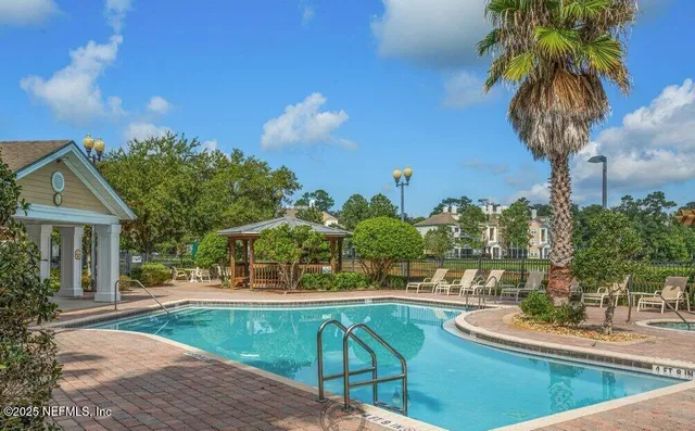 a view of a house with pool and trees