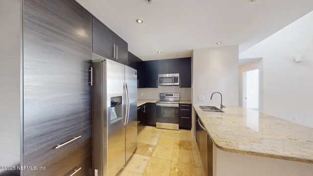 a kitchen with a refrigerator sink and stove