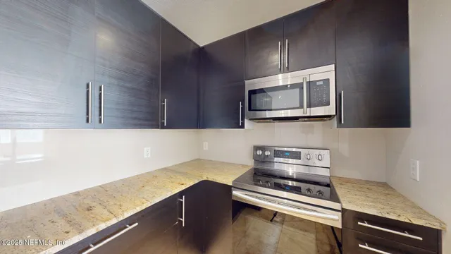 a kitchen with a stove microwave and sink