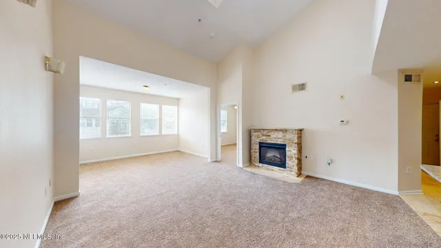 a view of empty room with a fireplace