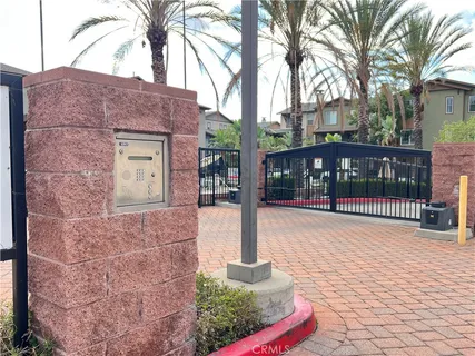 a front view of a house with a yard and potted plants