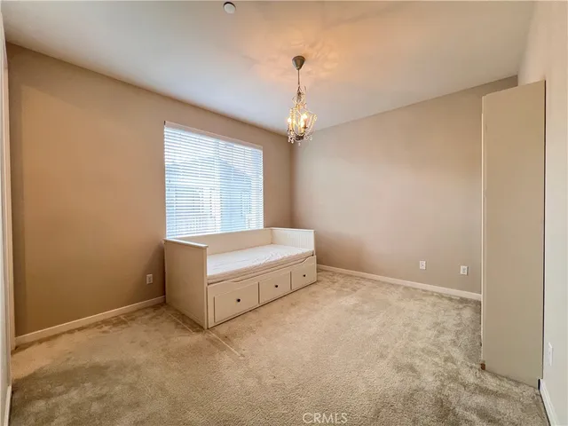 a spacious bedroom with a bed and a window