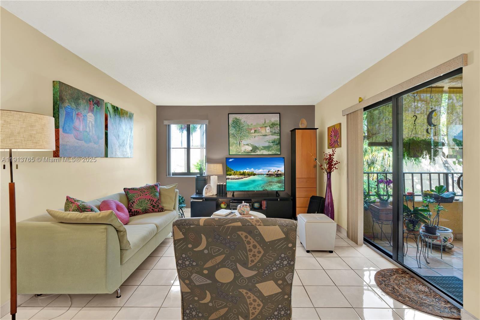 10857 Northwest 7th Street, Unit 2417 Miami, FL 33172 - Photo 11 of 35 a living room with furniture a floor to ceiling window and a flat screen tv