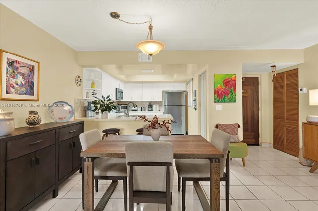 a view of a dining room with furniture and a chandelier