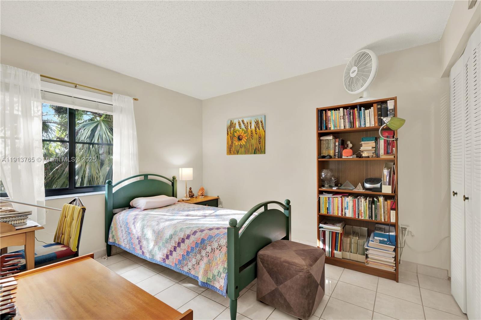 10857 Northwest 7th Street, Unit 2417 Miami, FL 33172 - Photo 22 of 35 a bedroom with a bed a dresser and a large window