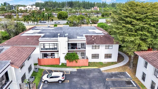 an aerial view of a house with a yard