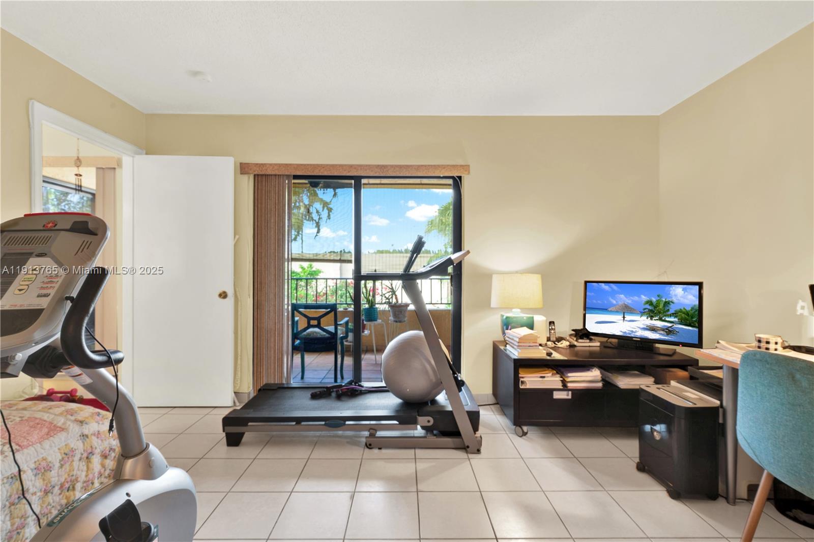 10857 Northwest 7th Street, Unit 2417 Miami, FL 33172 - Photo 31 of 35 a living room with furniture a flat screen tv and a floor to ceiling window