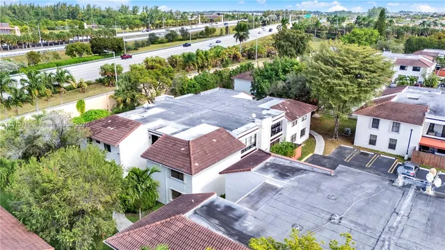 an aerial view of a house with garden space and street view