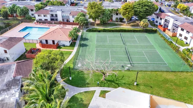 a aerial view of a multi story residential apartment building with a yard