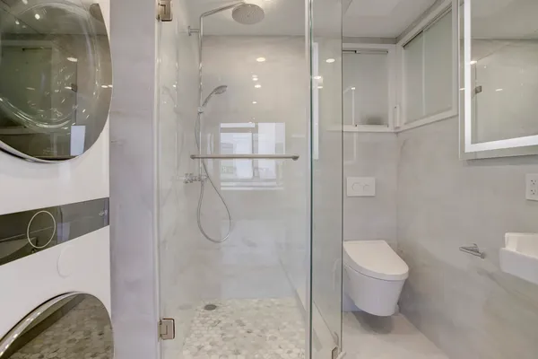 a bathroom with a toilet sink and shower