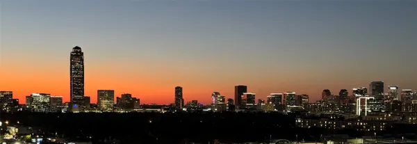 a view of a city with tall trees