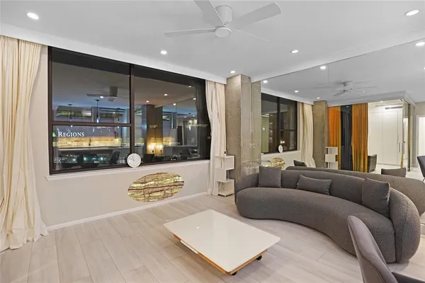 a living room with a couch and chandelier
