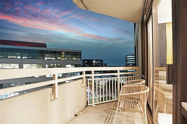 a view of a balcony with furniture