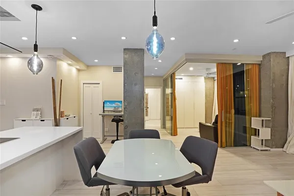 a large kitchen with a table and chairs