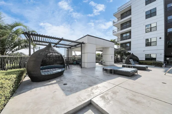 a large white kitchen with a sink and dishwasher a stove with wooden floor