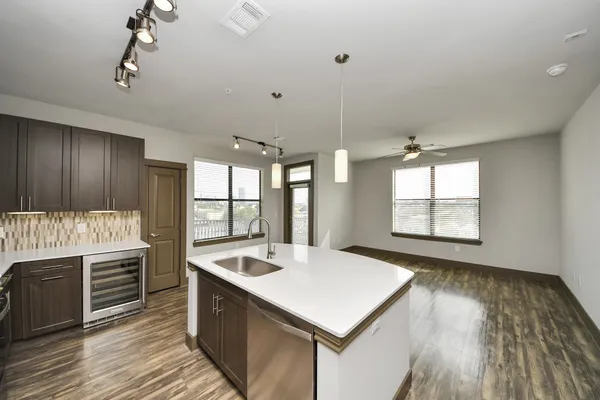 a view of a kitchen with wooden floor and staircase