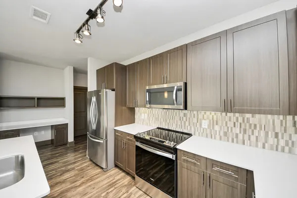 a bathroom with a granite countertop sink toilet a mirror and shower