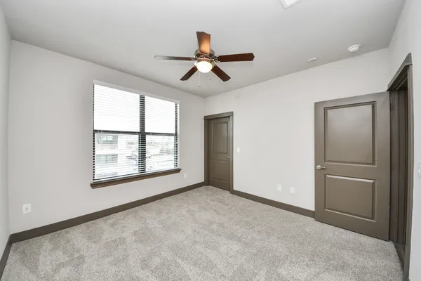 a large kitchen with a wooden floor and stainless steel appliances
