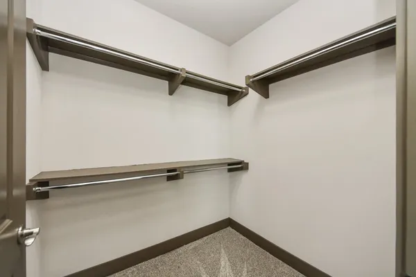 a large kitchen with cabinets wooden floor and stainless steel appliances