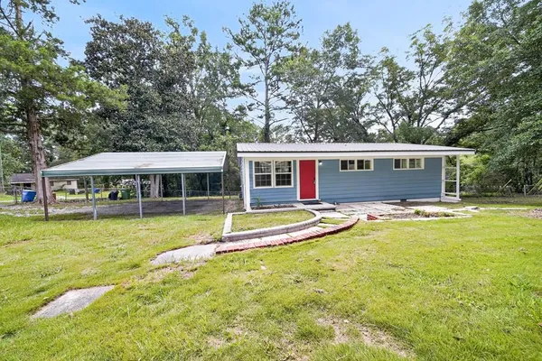 a view of a house with swimming pool and a yard