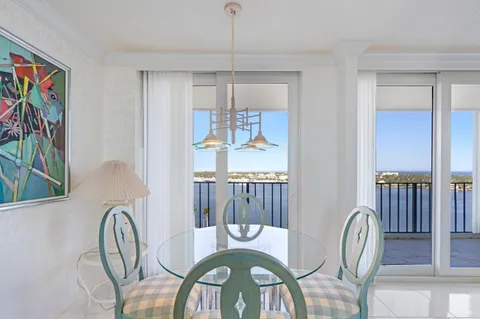 a dining room with furniture a rug and a chandelier