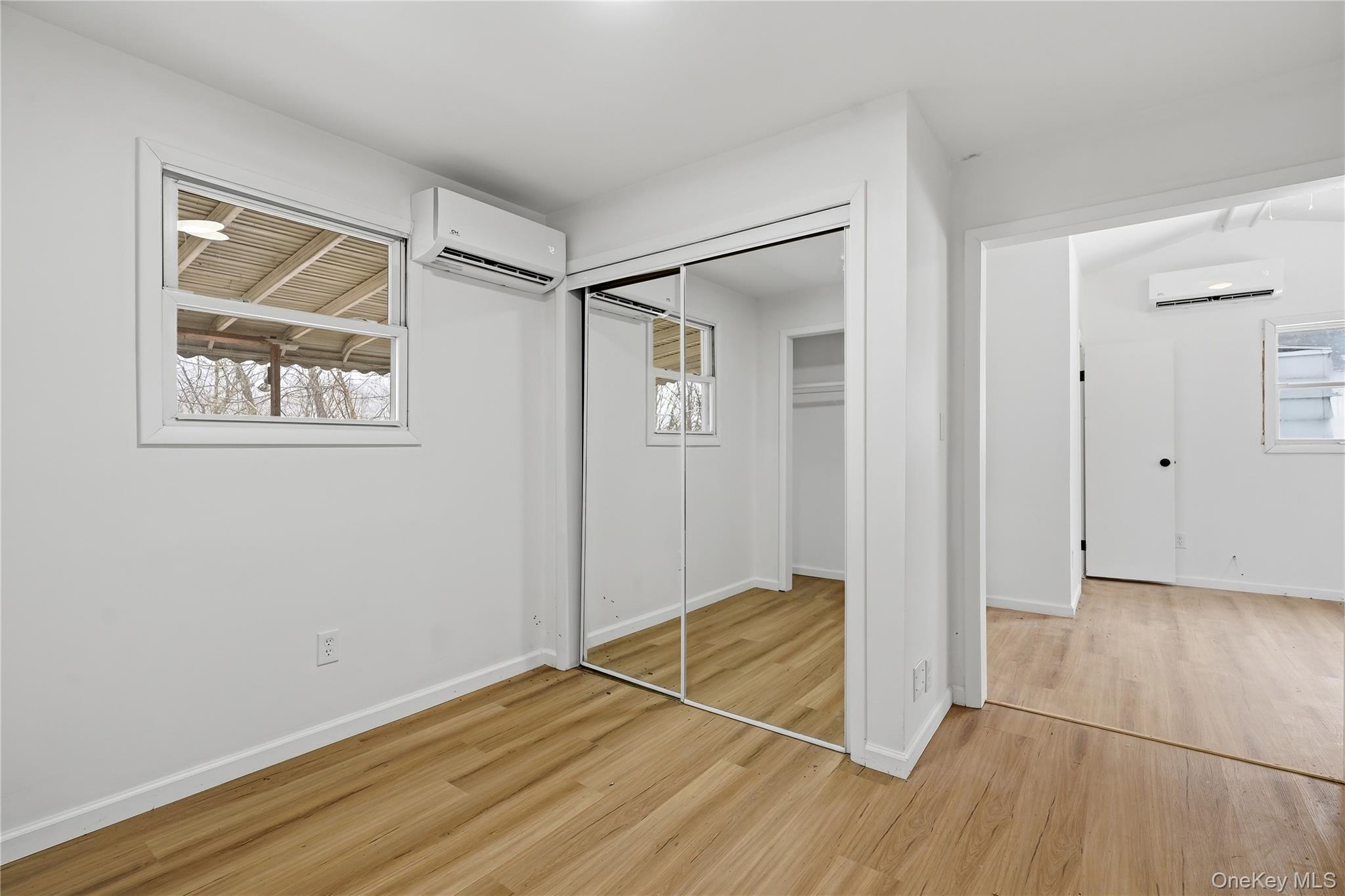 384 Tempaloni Road Ellenville, NY 12428 - Photo 11 of 18 a view of an empty room with wooden floor and a window