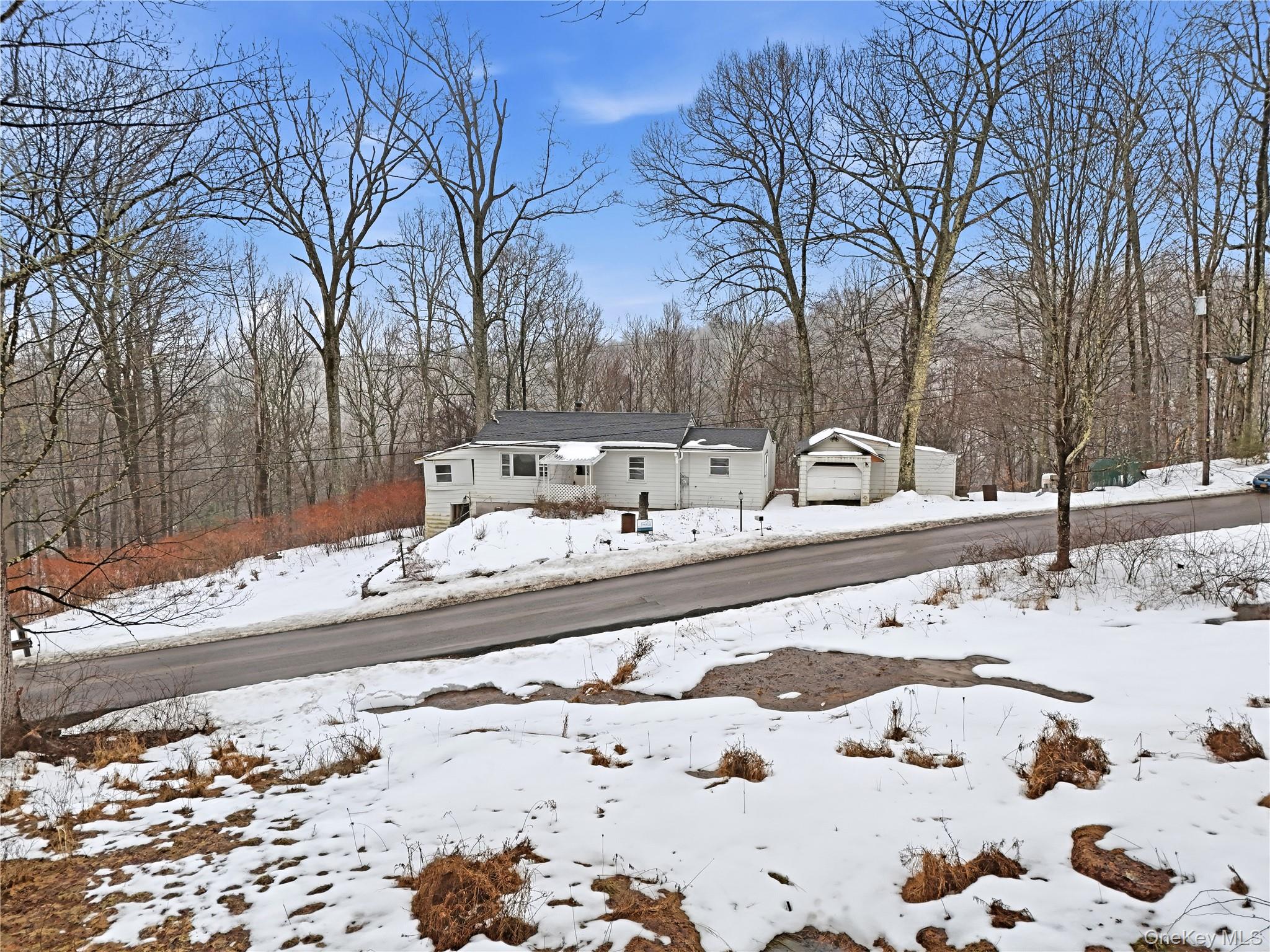 384 Tempaloni Road Ellenville, NY 12428 - Photo 18 of 18 a view of a backyard with snow on the road