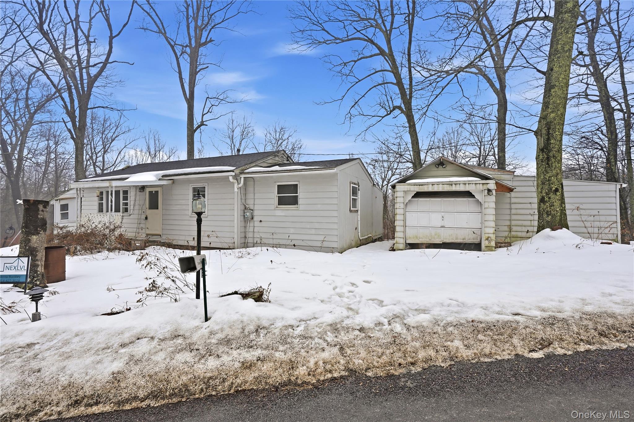 384 Tempaloni Road Ellenville, NY 12428 - Photo 2 of 18 a front view of a house with a yard covered in snow