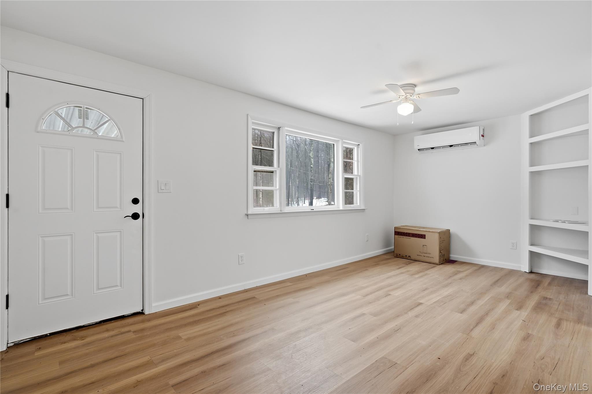 384 Tempaloni Road Ellenville, NY 12428 - Photo 3 of 18 a view of an empty room with wooden floor and a window
