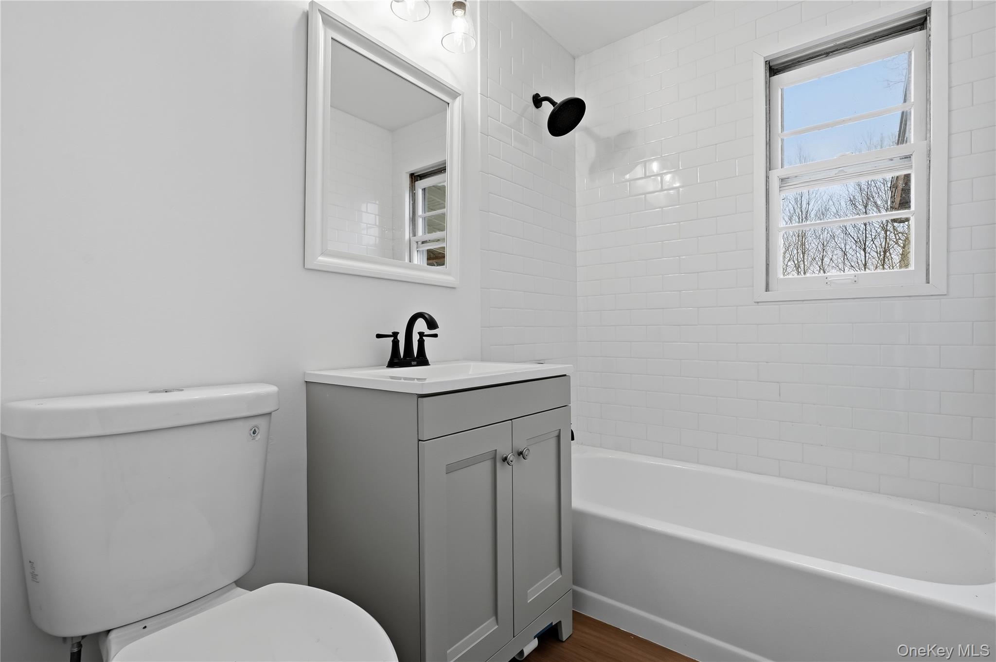 384 Tempaloni Road Ellenville, NY 12428 - Photo 8 of 18 a bathroom with a toilet sink and mirror