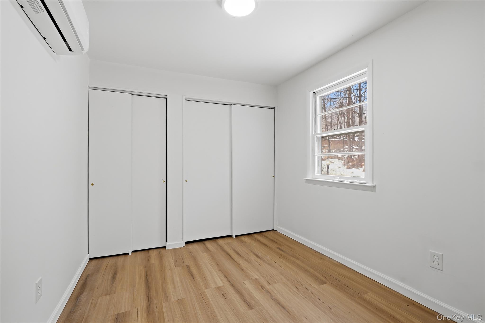 384 Tempaloni Road Ellenville, NY 12428 - Photo 9 of 18 a view of an empty room with wooden floor and a window