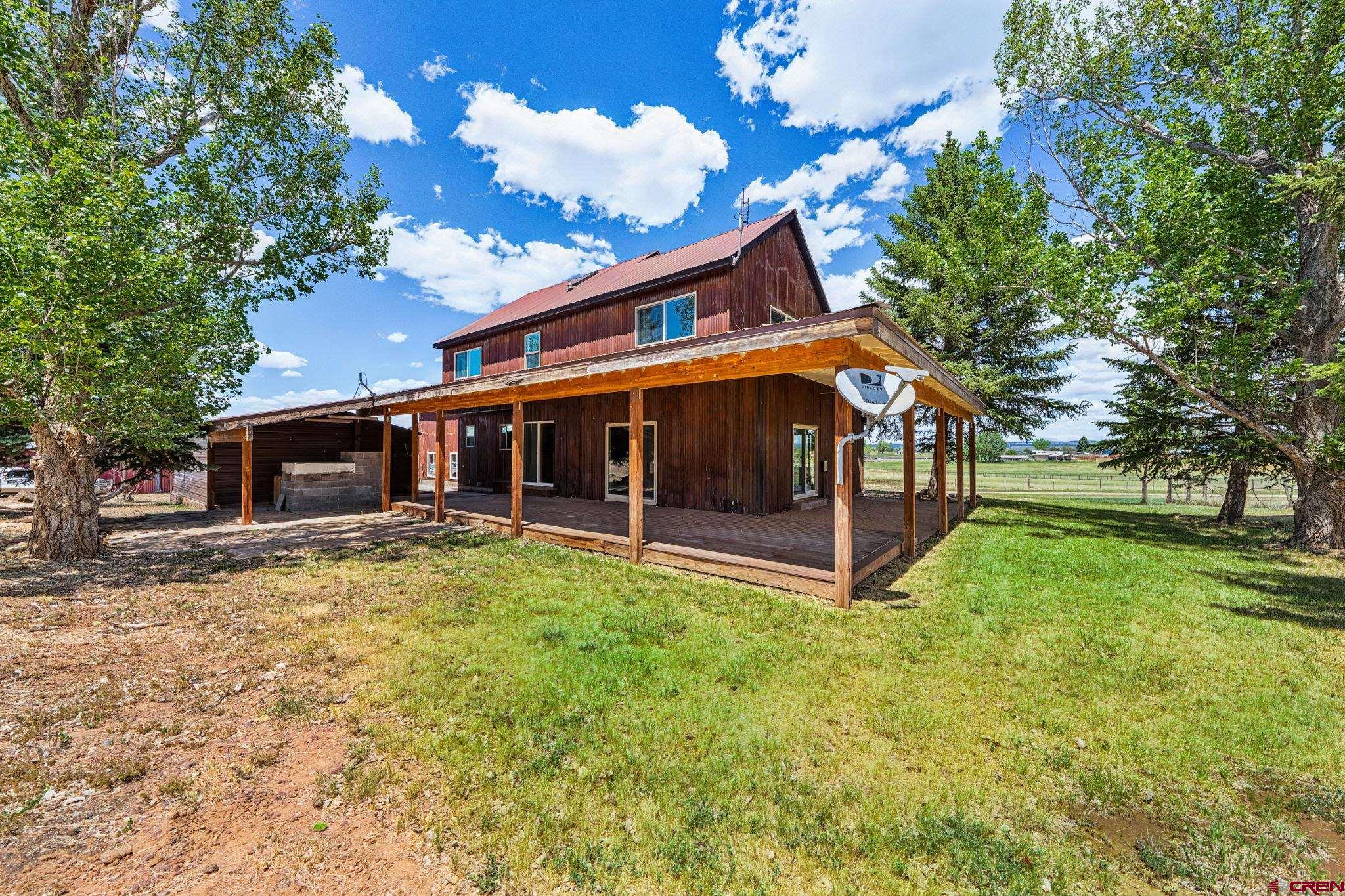 22480 Rd L Cortez, CO 81321 - Photo 30 of 44 a view of a house with a yard and sitting area