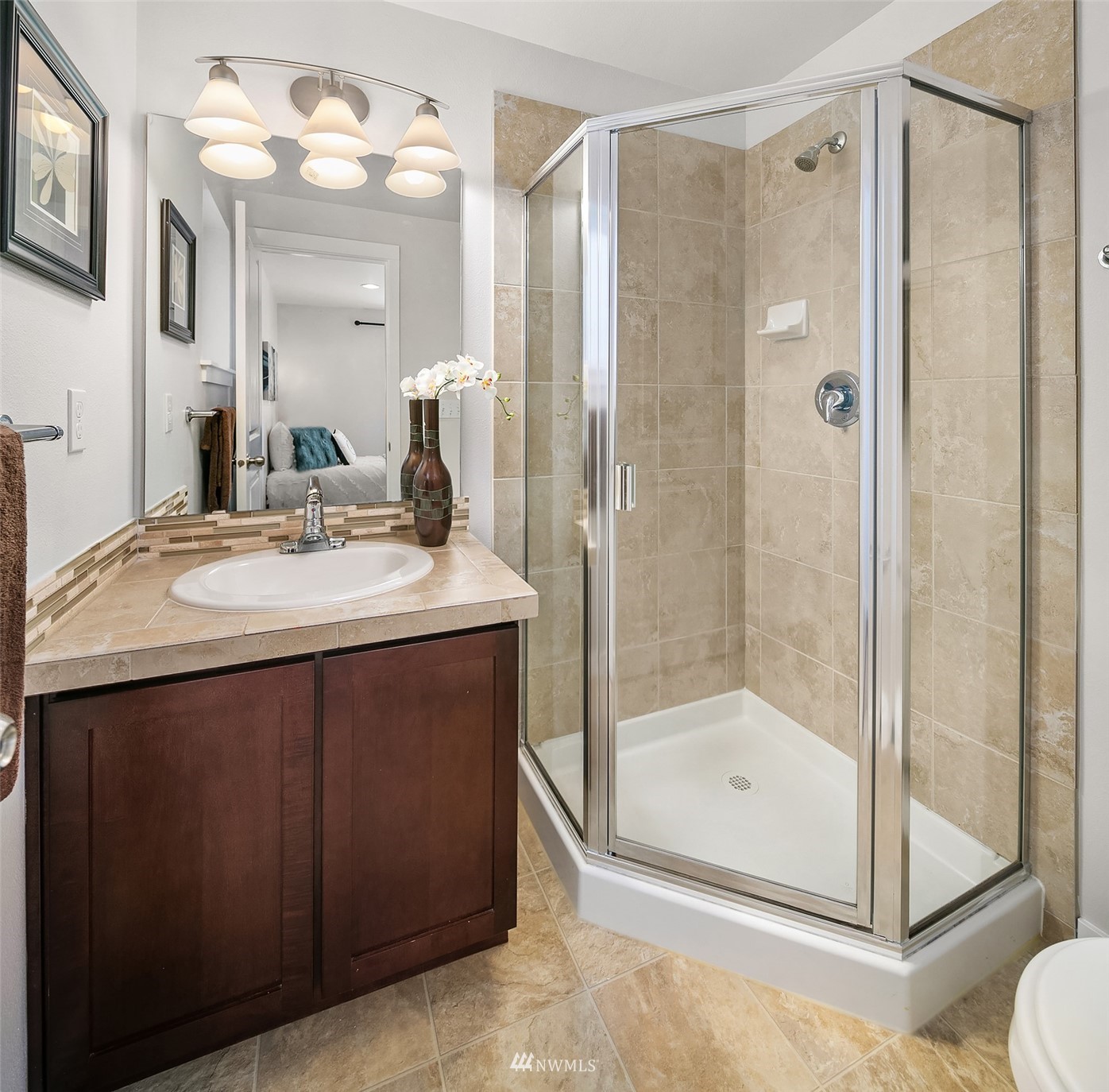 926 North 96th Street Seattle, WA 98103 - Photo 5 of 16 a bathroom with a shower sink vanity and mirror