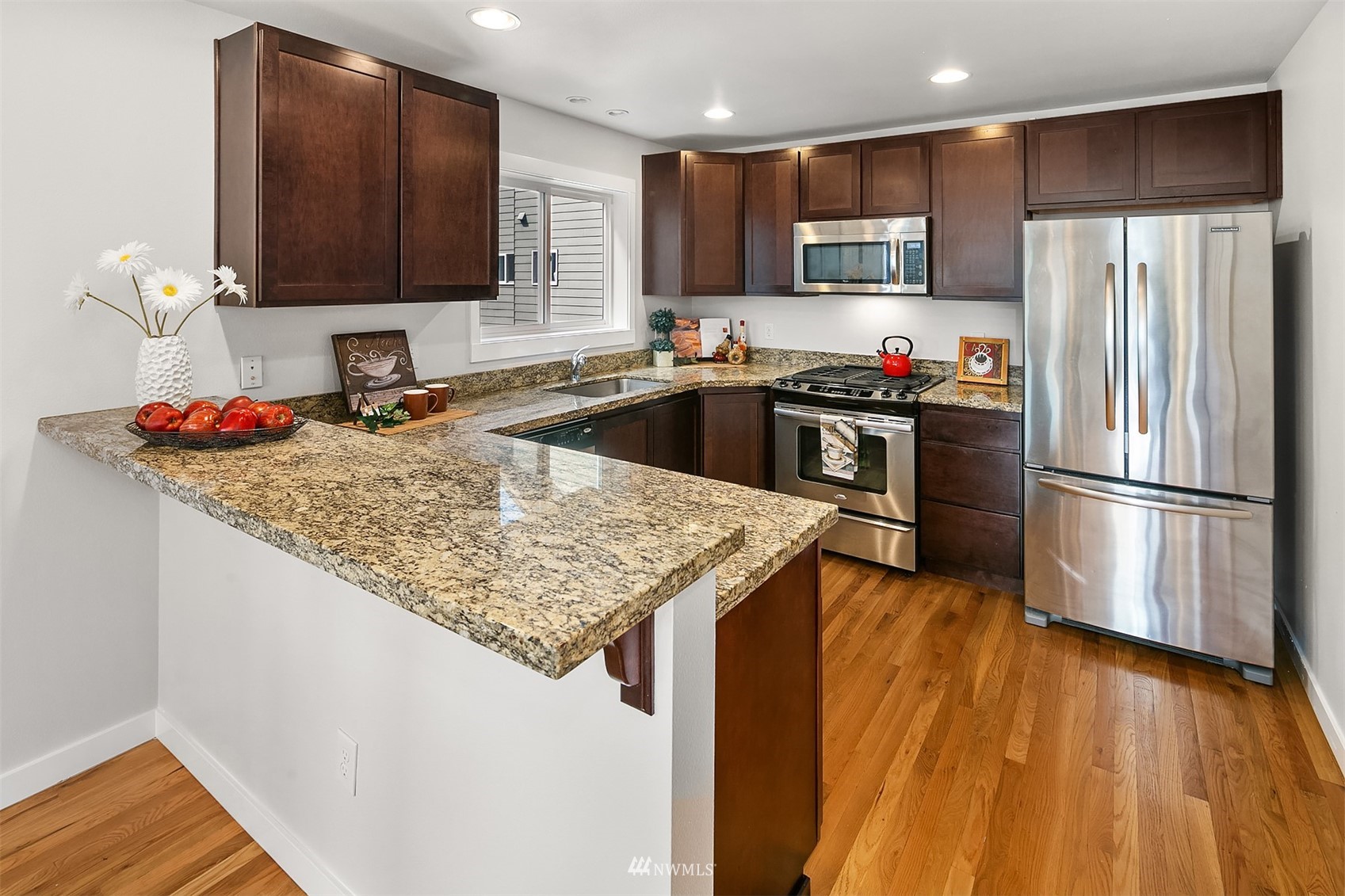926 North 96th Street Seattle, WA 98103 - Photo 8 of 16 a kitchen with stainless steel appliances granite countertop a refrigerator sink and microwave