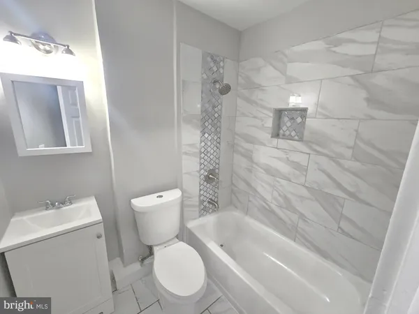 a bathroom with a toilet and a bathtub