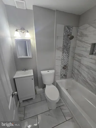 a bathroom with a toilet sink and shower