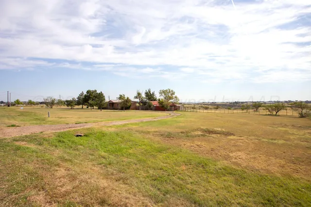a view of a big yard with an trees