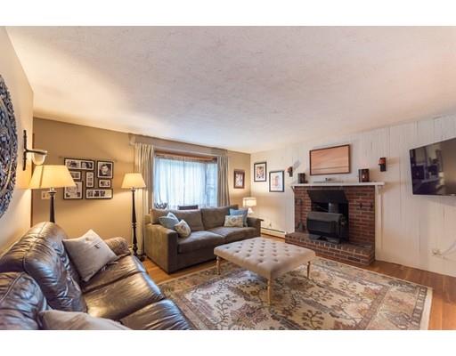 67 Folly Mill Road Salisbury, MA 01952 - Photo 9 of 28 a living room with furniture a fireplace and a flat screen tv