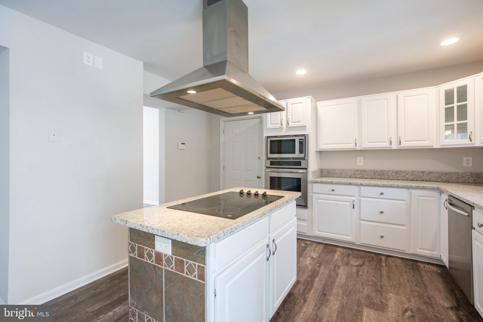 4365 Harvey Road Huntingtown, MD 20639 - Photo 15 of 36 a kitchen that has a sink and a stove in it