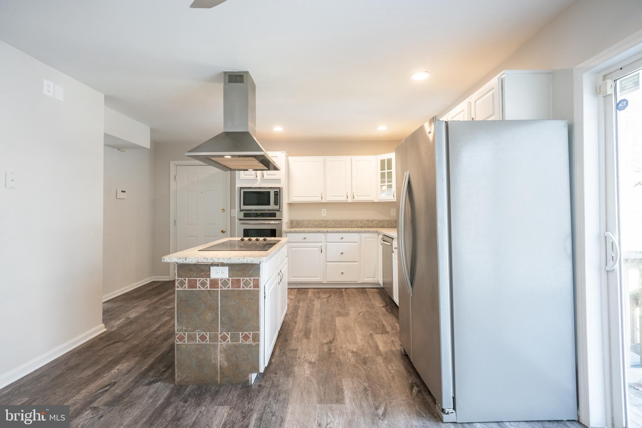 4365 Harvey Road Huntingtown, MD 20639 - Photo 16 of 36 a kitchen with stainless steel appliances a stove a refrigerator and a oven