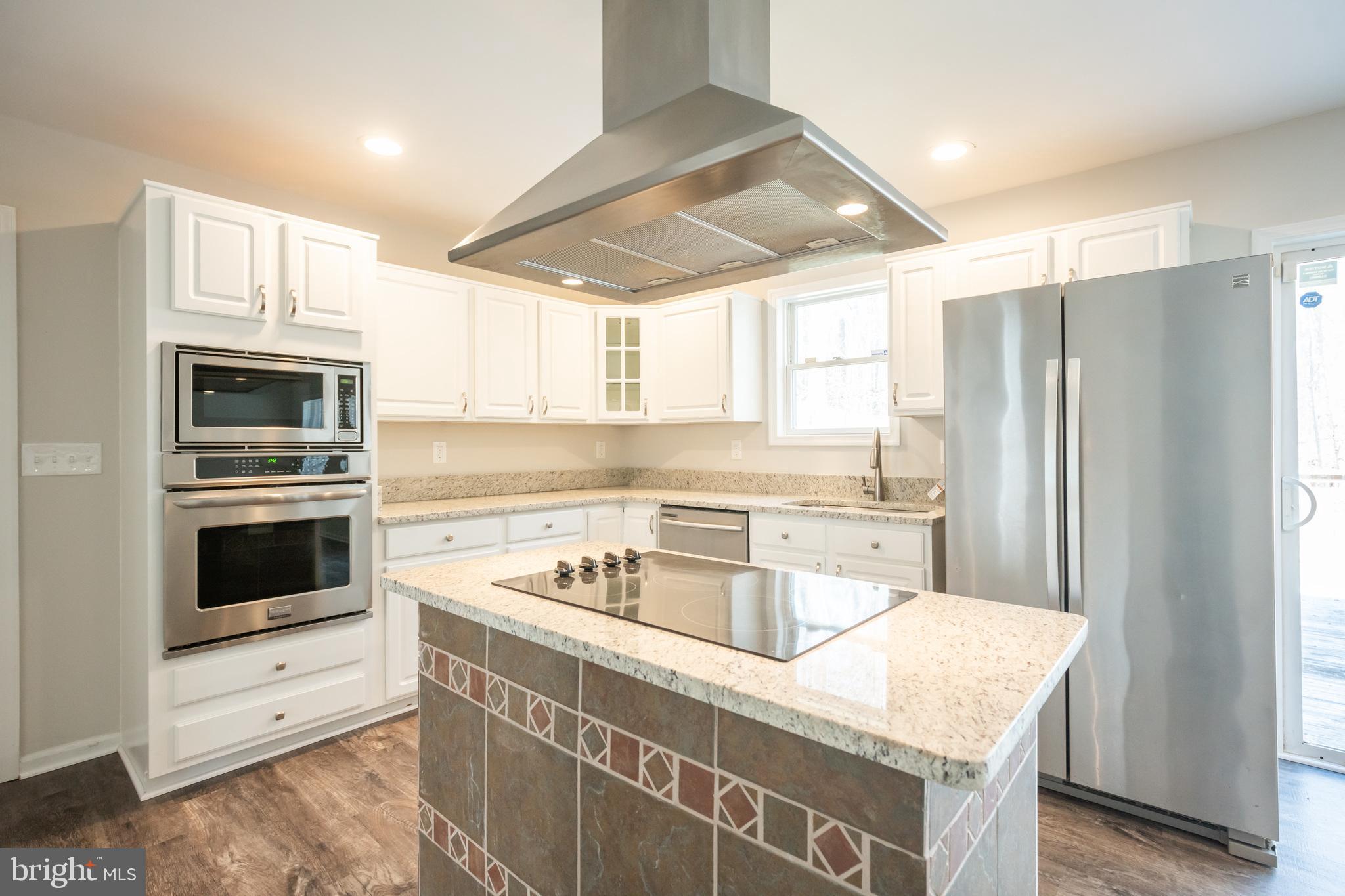 4365 Harvey Road Huntingtown, MD 20639 - Photo 17 of 36 a kitchen with a stove a sink and a refrigerator