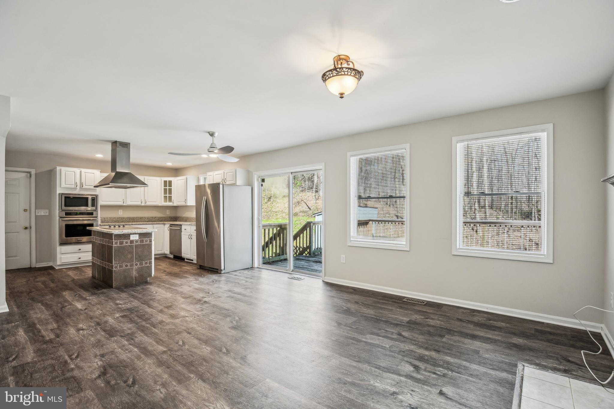4365 Harvey Road Huntingtown, MD 20639 - Photo 19 of 36 a view of a kitchen with furniture and wooden floor